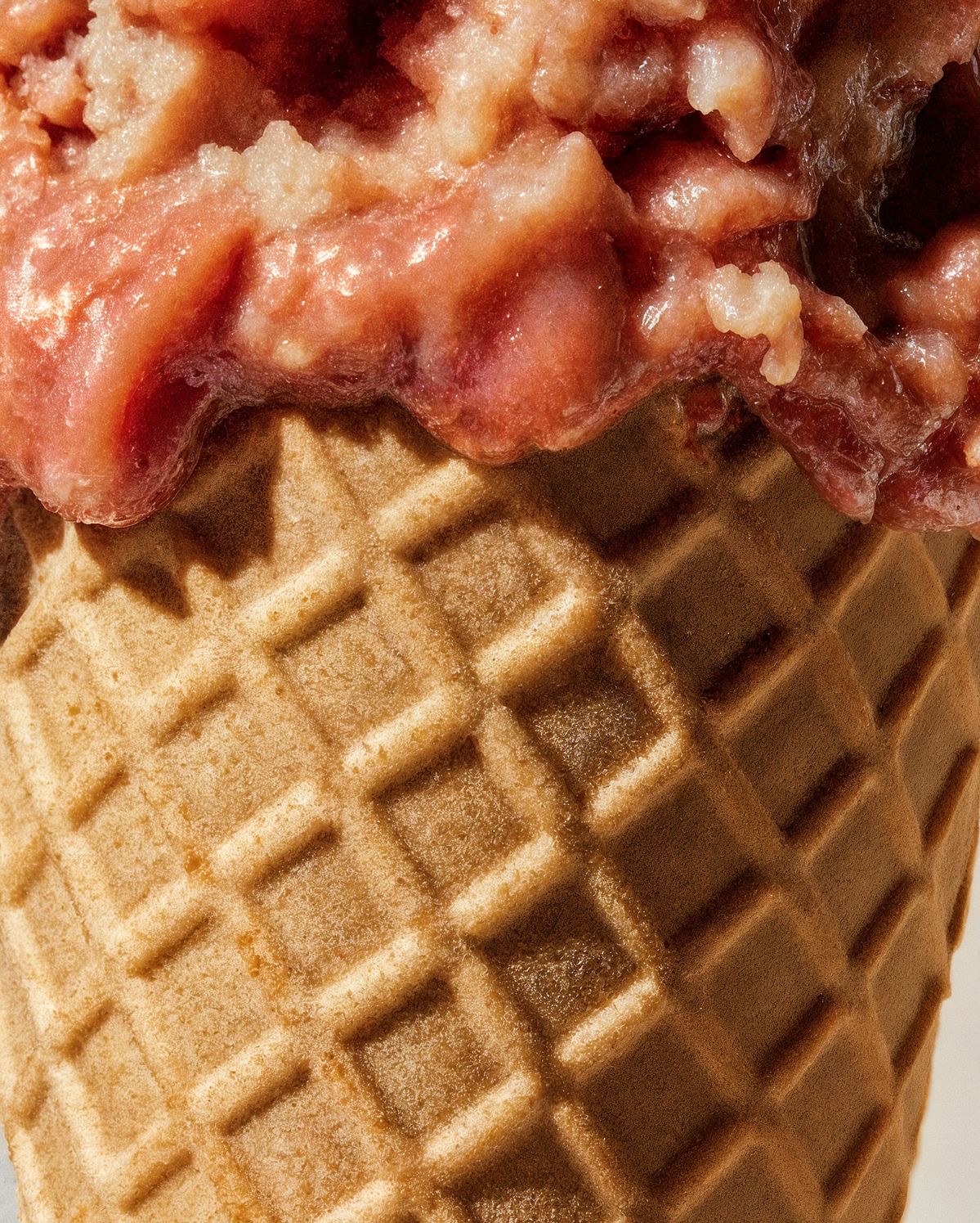 Cherry ice cream scoop in a waffle cone